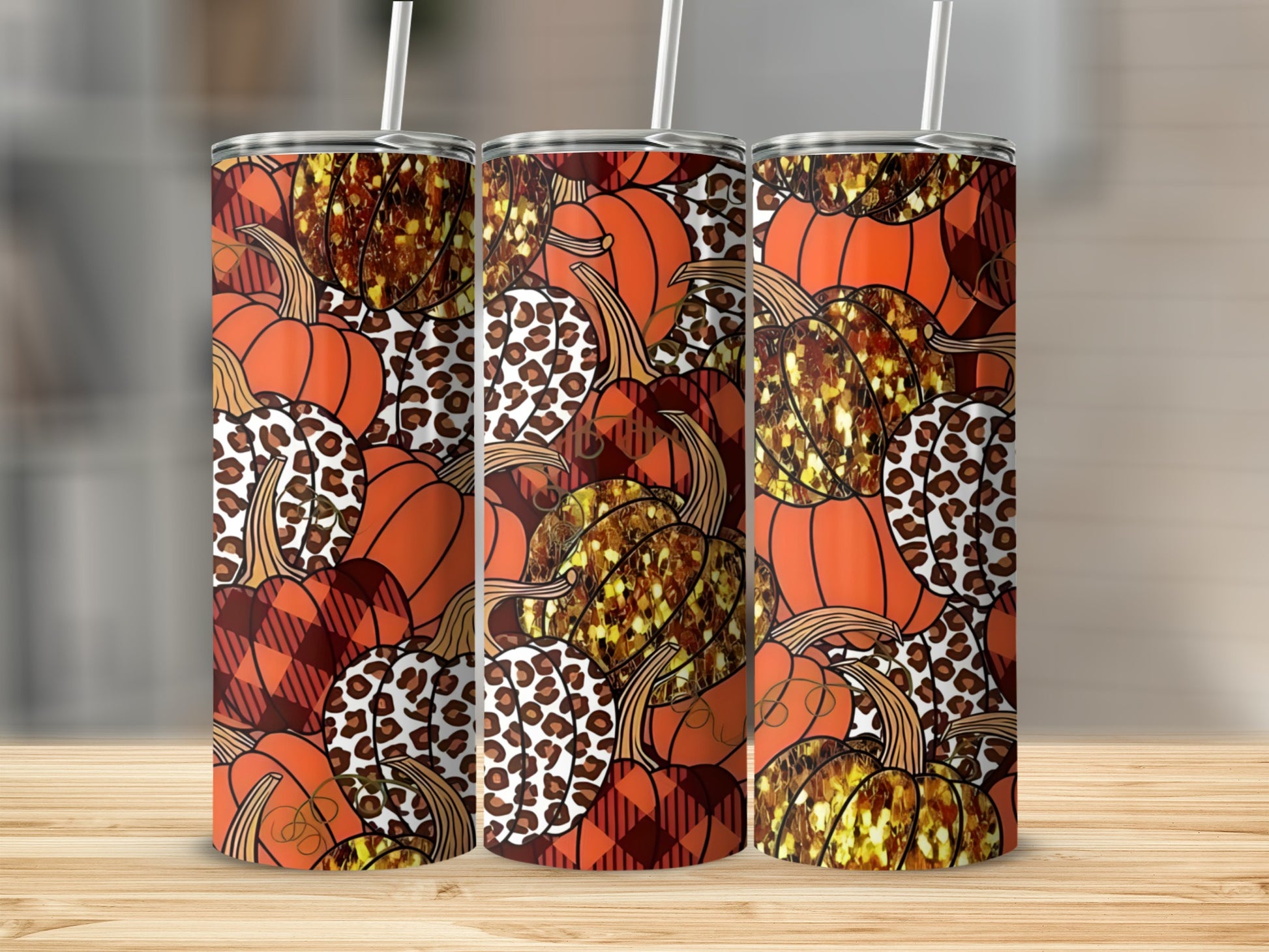 Three tumblers with pumpkin, leopard, and plaid patterns.