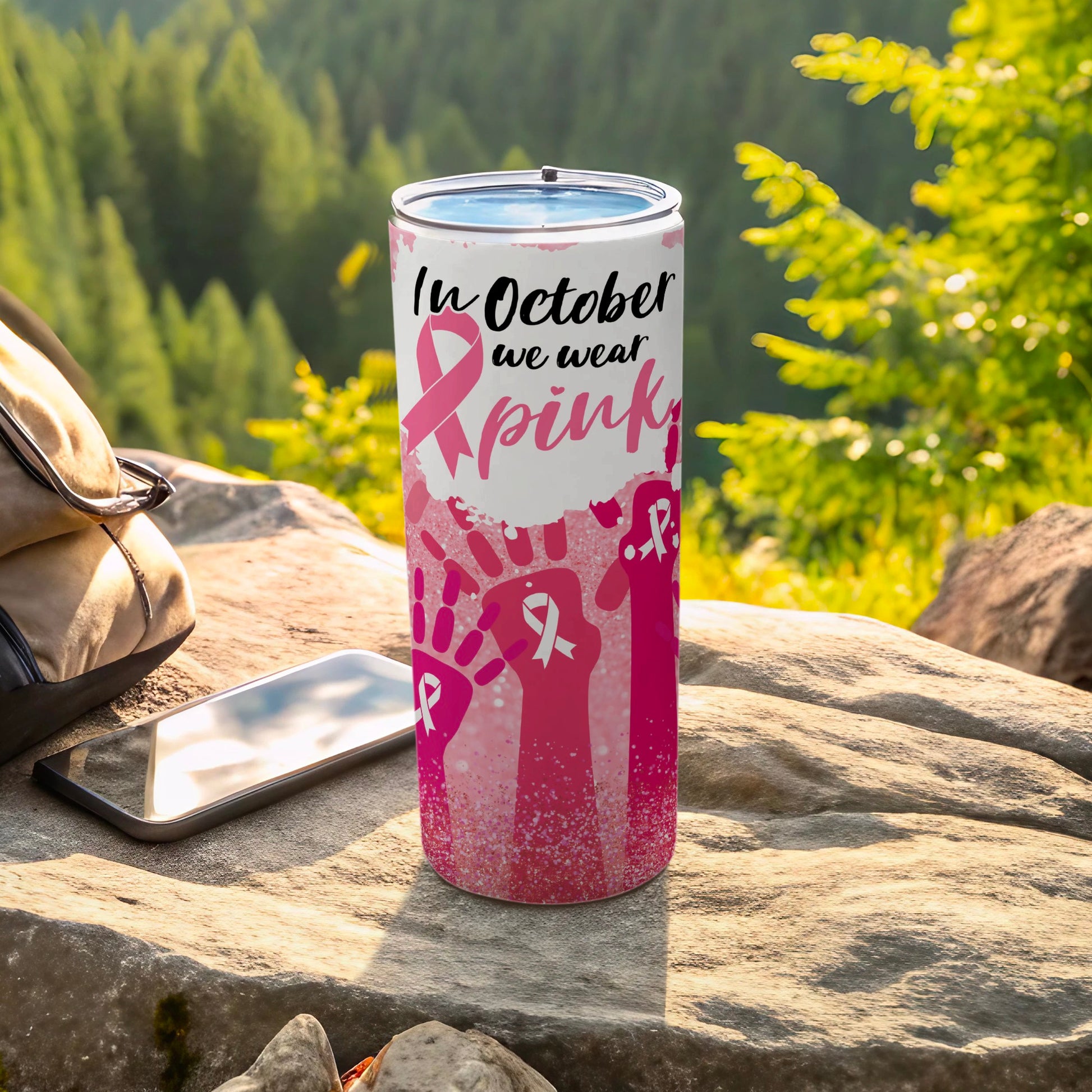 Pink tumbler with "In October we wear pink" and handprint design.