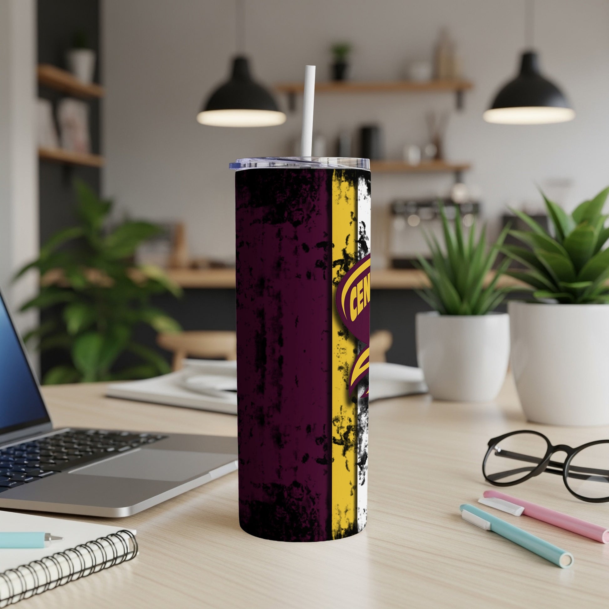 Tumbler with maroon and gold grunge design and logo.