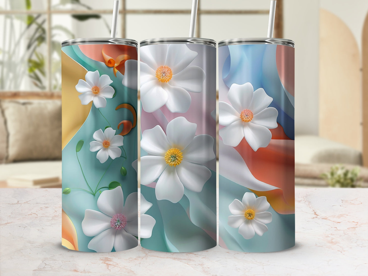 Three tumblers with floral designs and colorful abstract backgrounds.