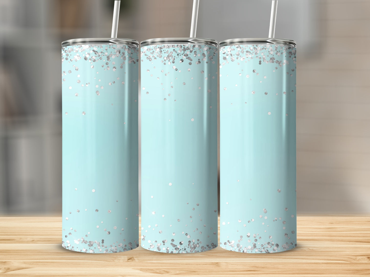 Three teal tumblers with silver glitter accents and straws.