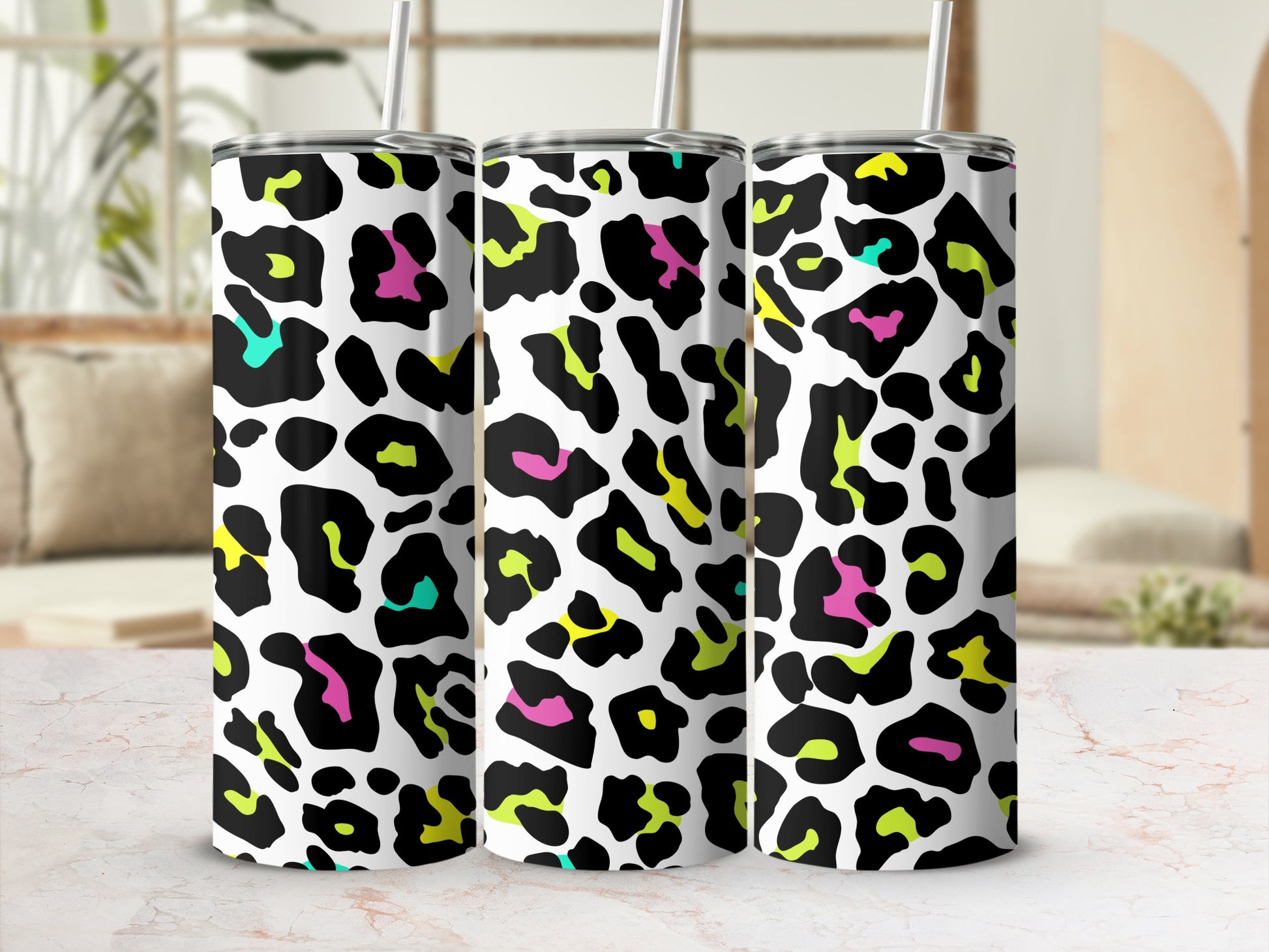 Three tumblers with a white background and colorful leopard print pattern.