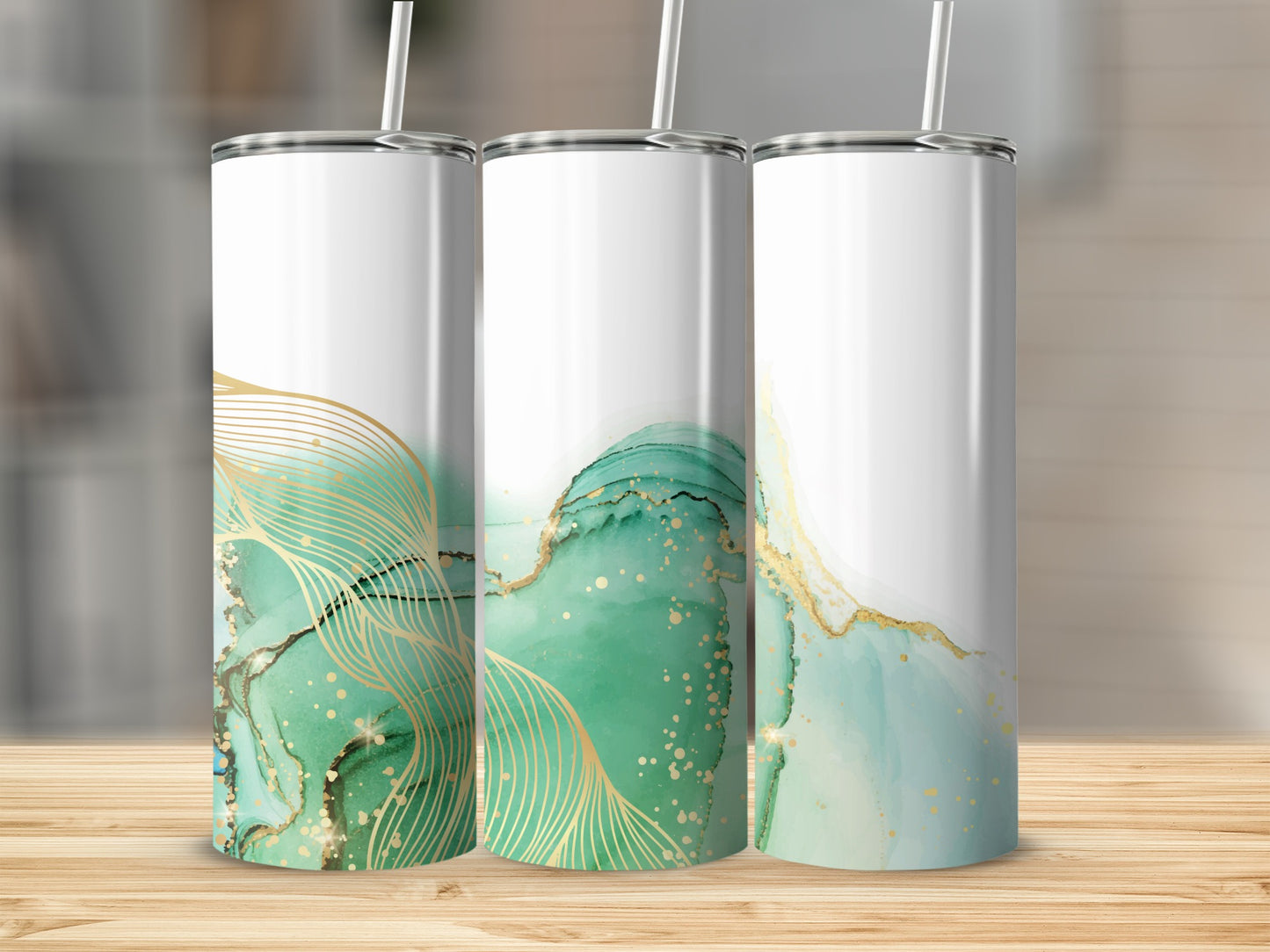 Three tumblers with green and gold abstract art designs.