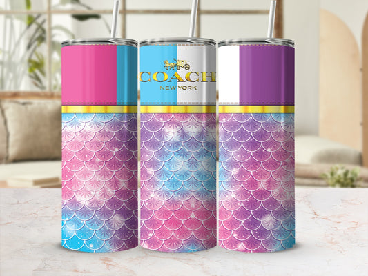 Three tumblers with pink, blue, and purple mermaid scale designs and Coach New York branding.