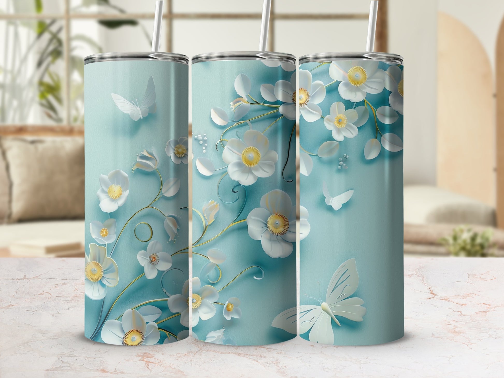 Three tumblers with white flowers, green vines, and butterflies on a light blue background.