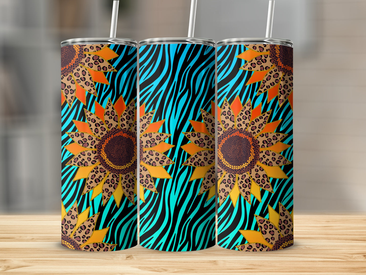 Three tumblers with teal zebra stripes and sunflower leopard print patterns.