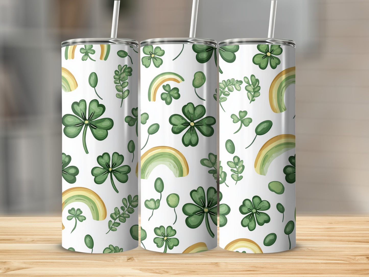 Pattern of shamrocks, leaves, and rainbows on three tumblers.
