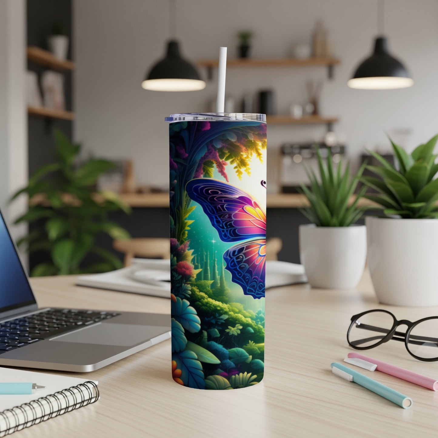 Tall tumbler with vibrant butterfly and floral design on a desk.