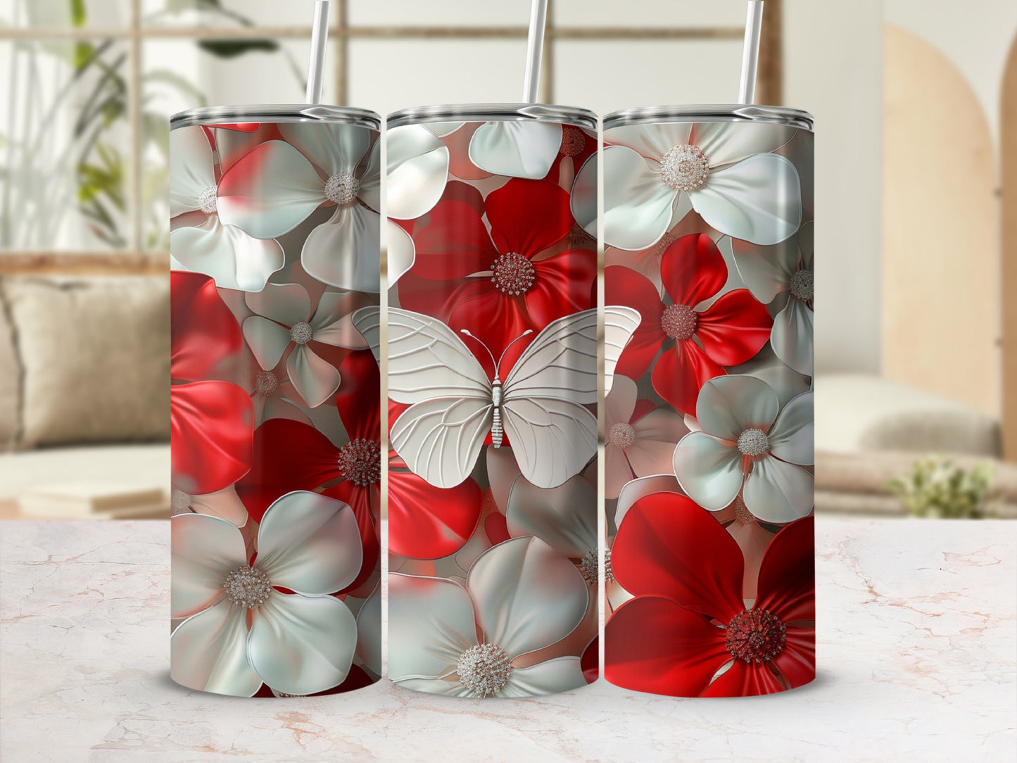 Three tumblers with a white butterfly and red and white flowers.