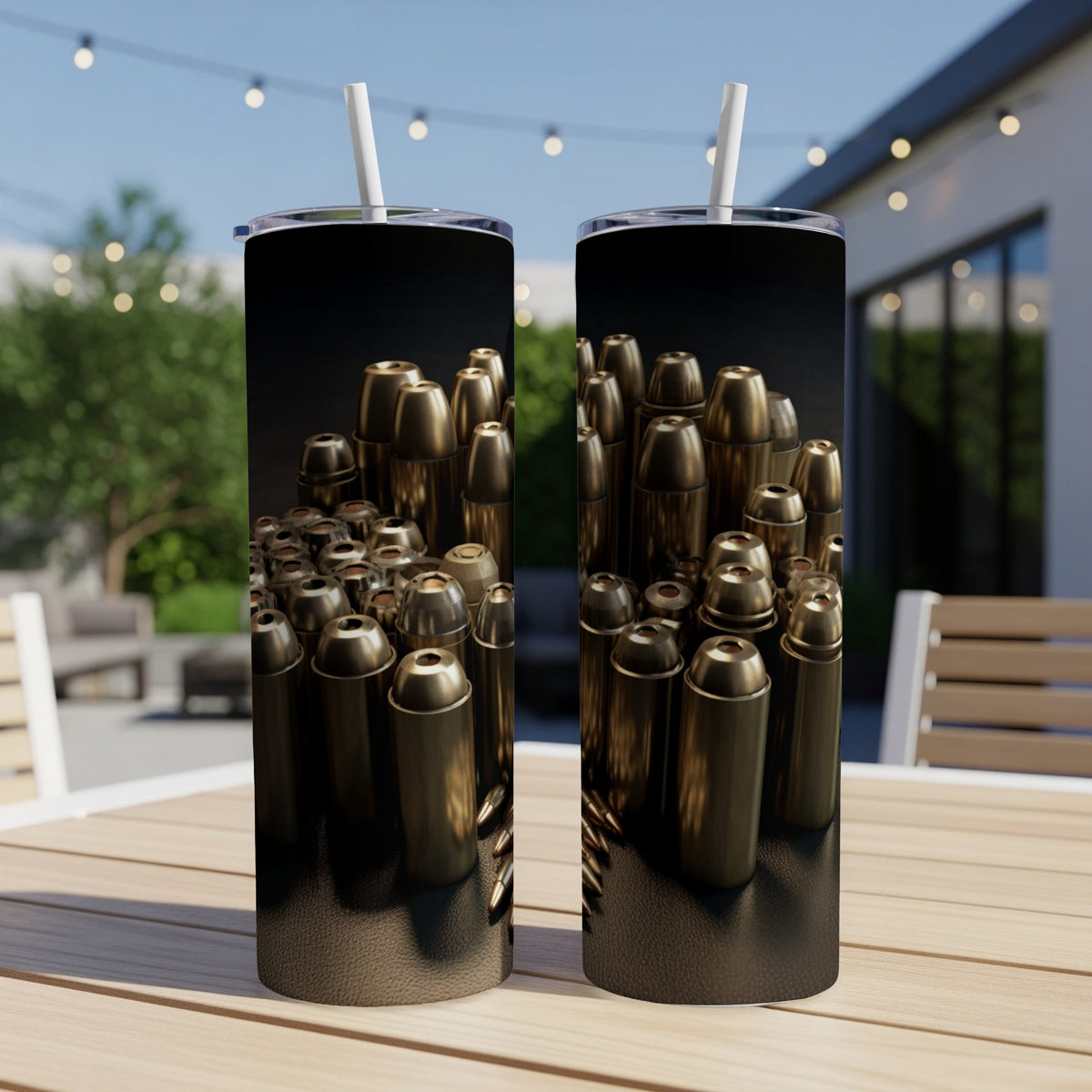 Two tumblers with brass bullet casings design and white straws.