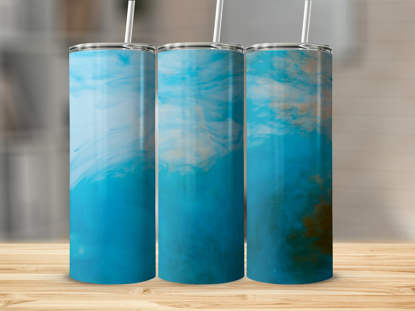 Three tumblers with blue and white marbled design and straws.