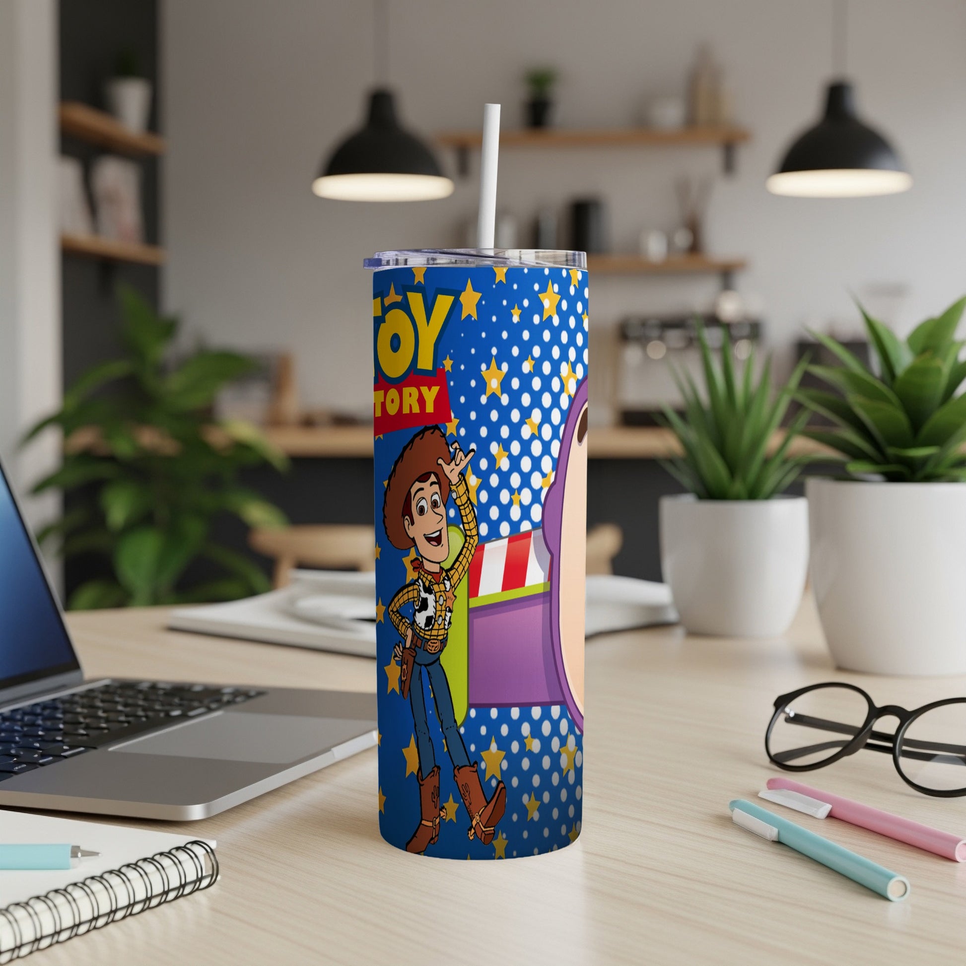 Toy Story tumbler with Woody and Buzz Lightyear characters on blue speckled background.
