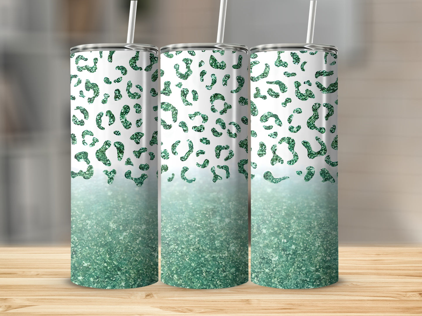 Three tumblers with green glitter leopard print fading to solid glitter.