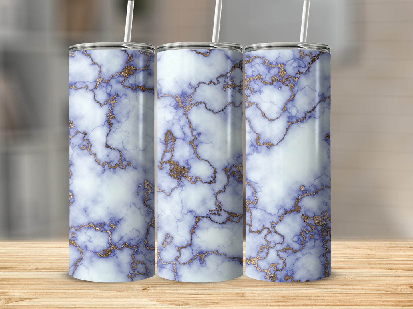 Three stainless steel tumblers with blue and gold marble pattern.