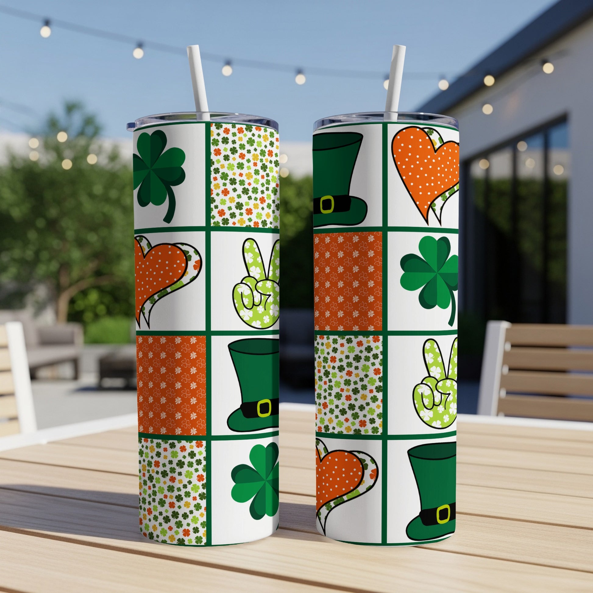 Two St. Patrick's Day themed tumblers with shamrocks, hearts, and top hats.