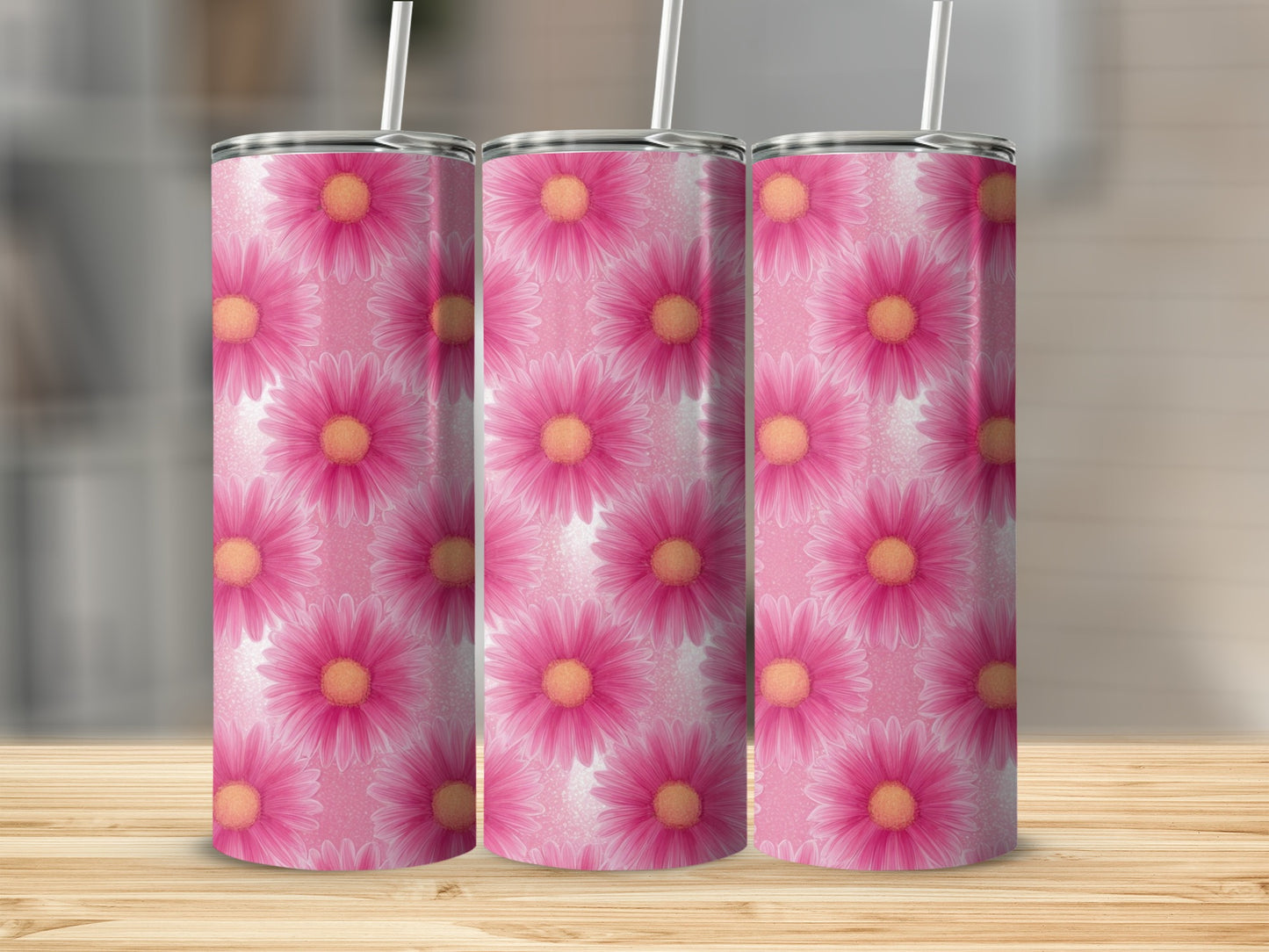 Three tumblers with pink daisy pattern and white straws.