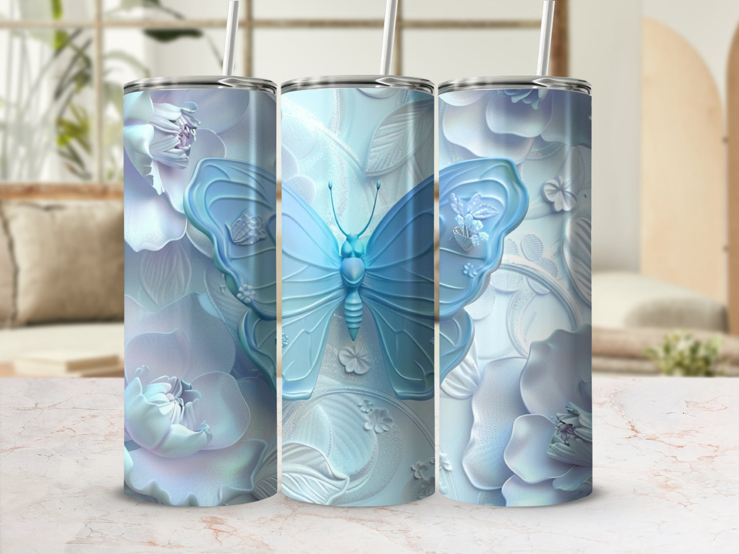 Three iridescent tumblers with embossed blue butterflies and floral designs.