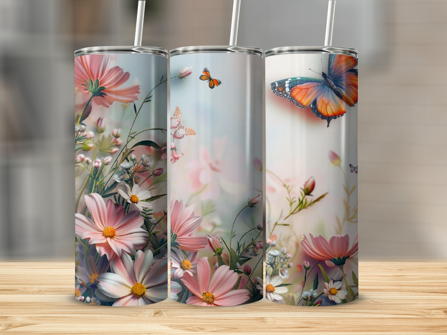 Three tumblers with floral and butterfly designs.