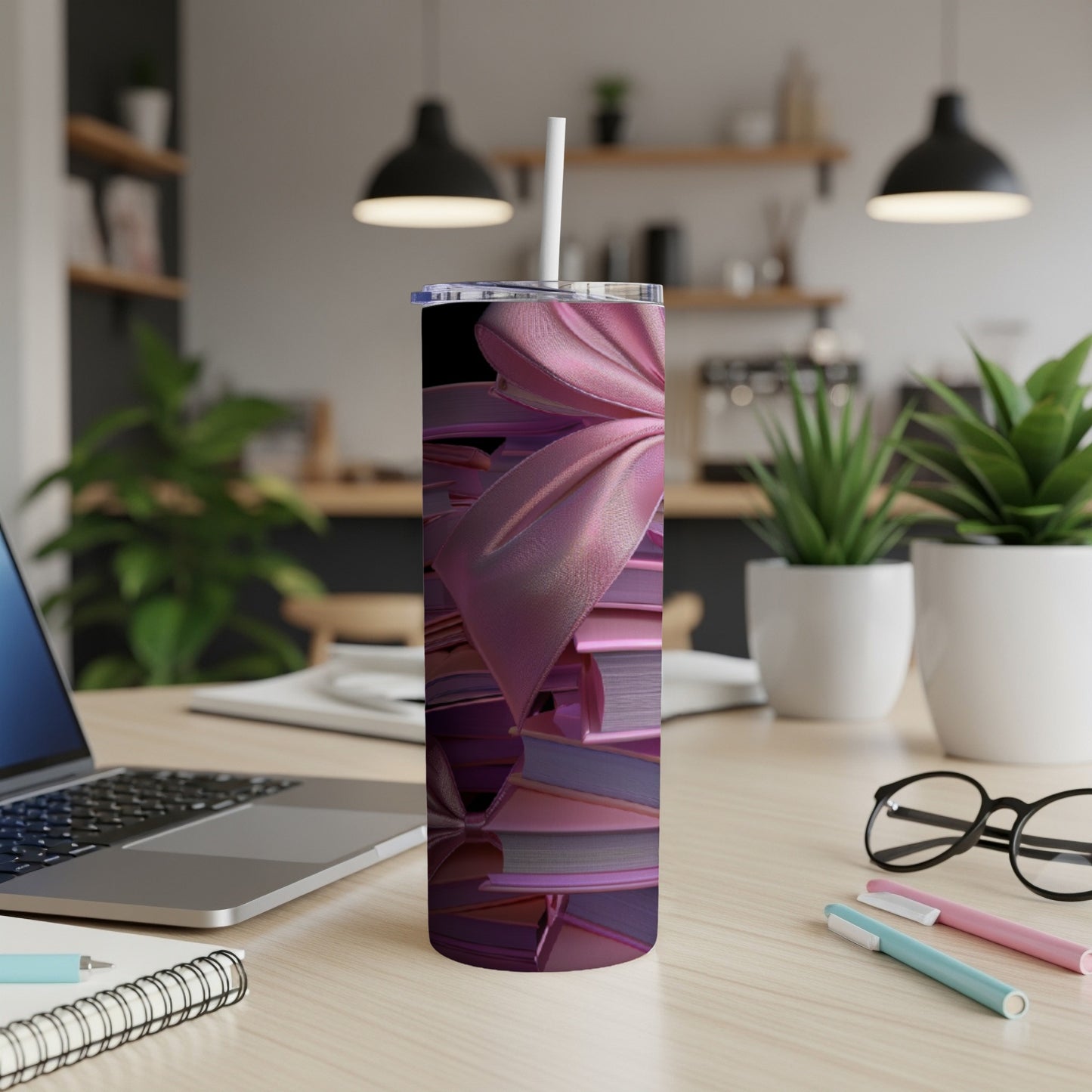Pink satin bow art on a tumbler with a straw.