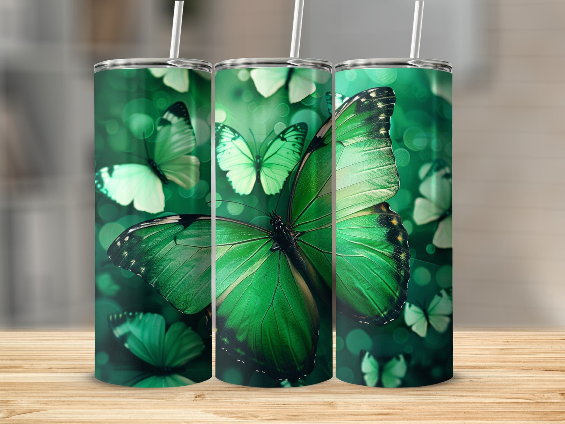 Green butterfly pattern on a stainless steel tumbler with straws.