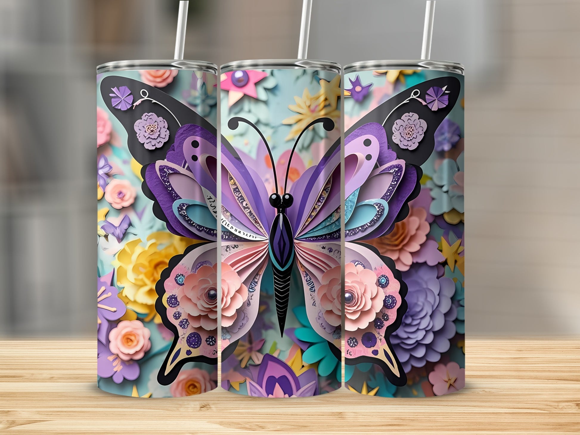 Three tumblers decorated with colorful paper butterfly and floral designs.