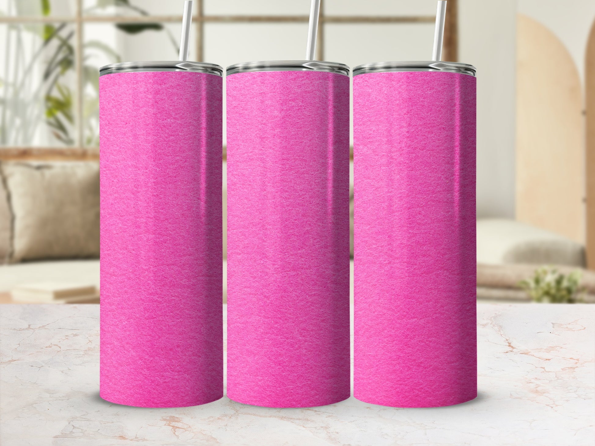 Three pink tumblers with straws stand in a row on a marble surface.