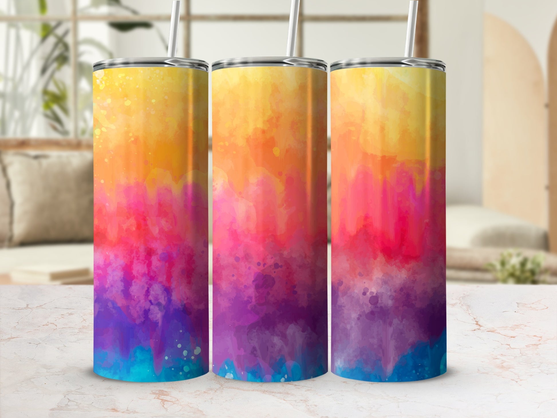 Three tumblers with a watercolor gradient design featuring yellow, orange, pink, purple, and blue.