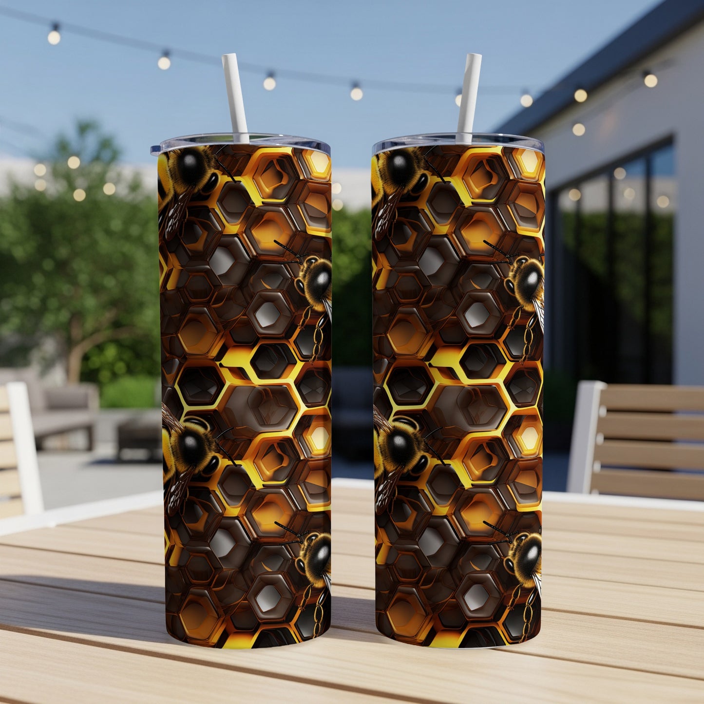 Two tall tumblers with a honeycomb and bee design.