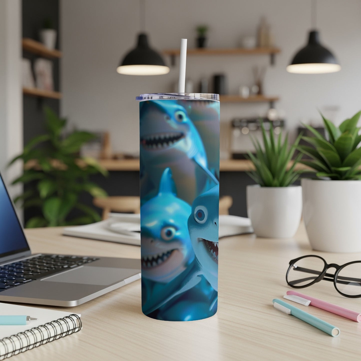 Blue shark print on a white insulated tumbler with a straw.