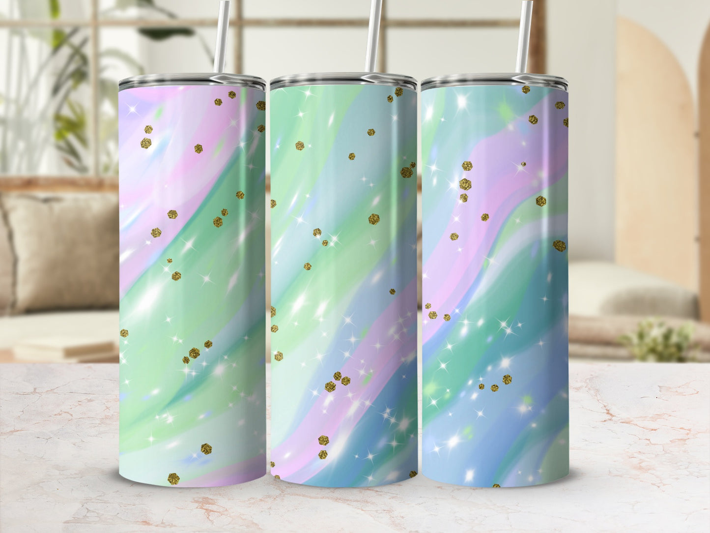 Three tumblers with pastel marble patterns and gold glitter accents.