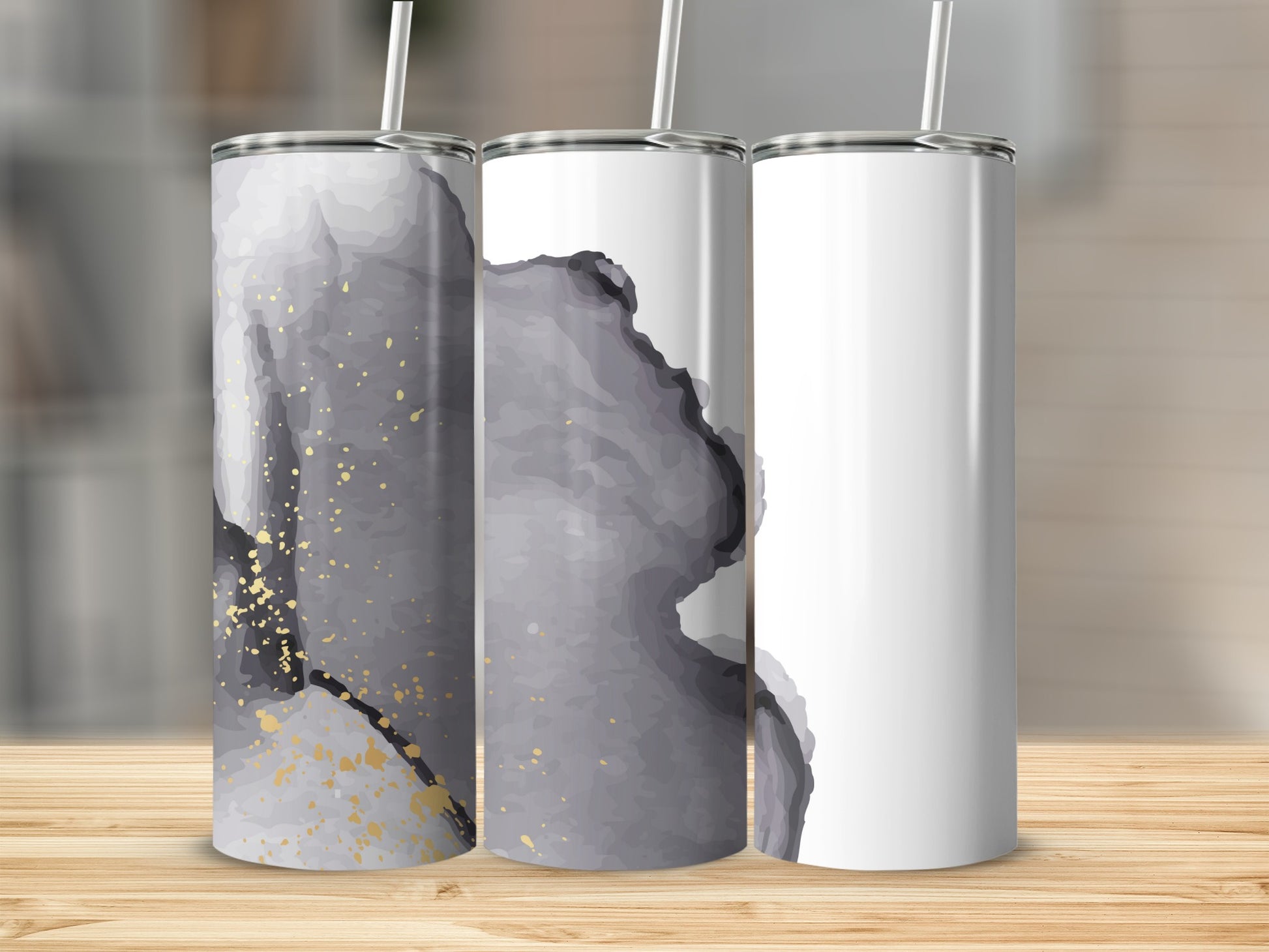 Three tumblers with abstract gray and gold marble design, one blank.