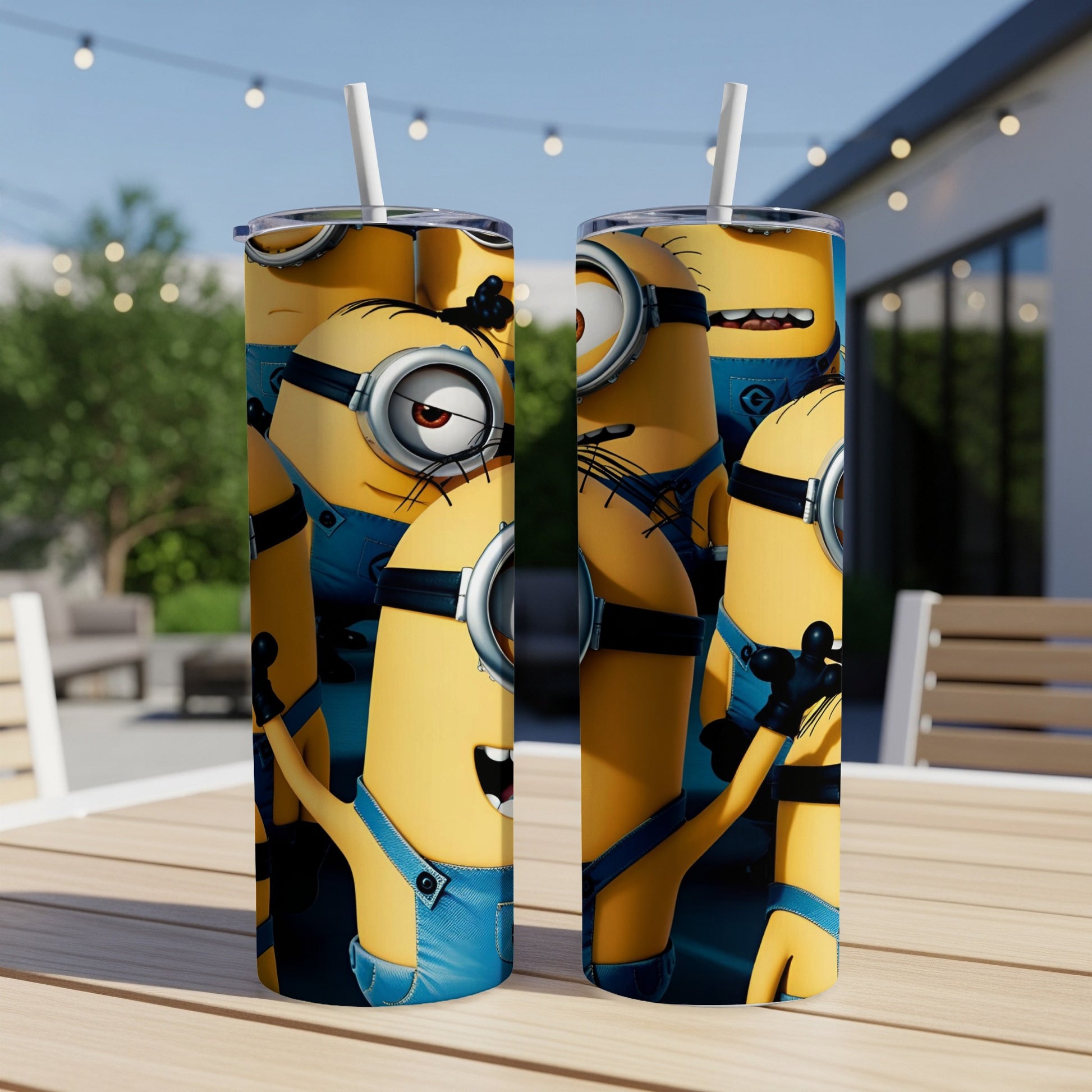Two Minions tumblers with blue overalls and goggles on a table.