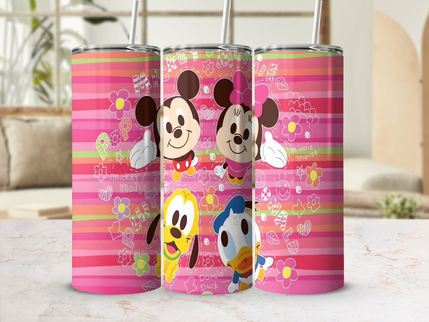 Three Disney character tumblers with Mickey, Minnie, Pluto, and Donald on a pink striped background.