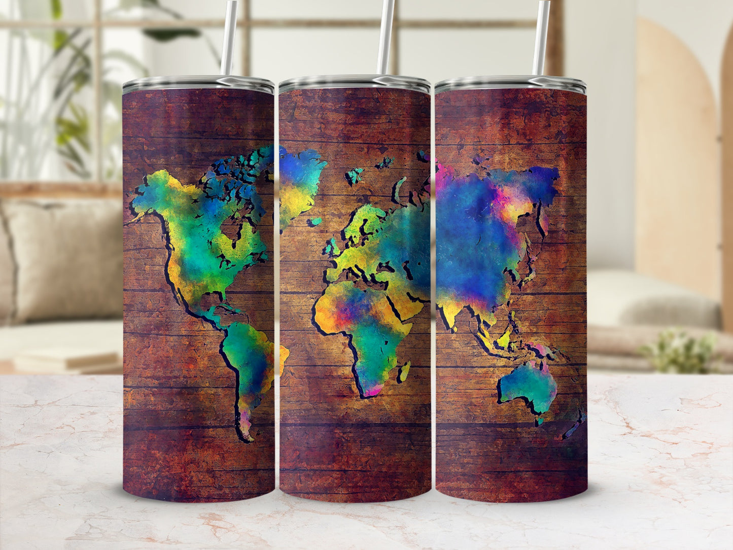 Three tumblers with a colorful world map design on a wood grain background.