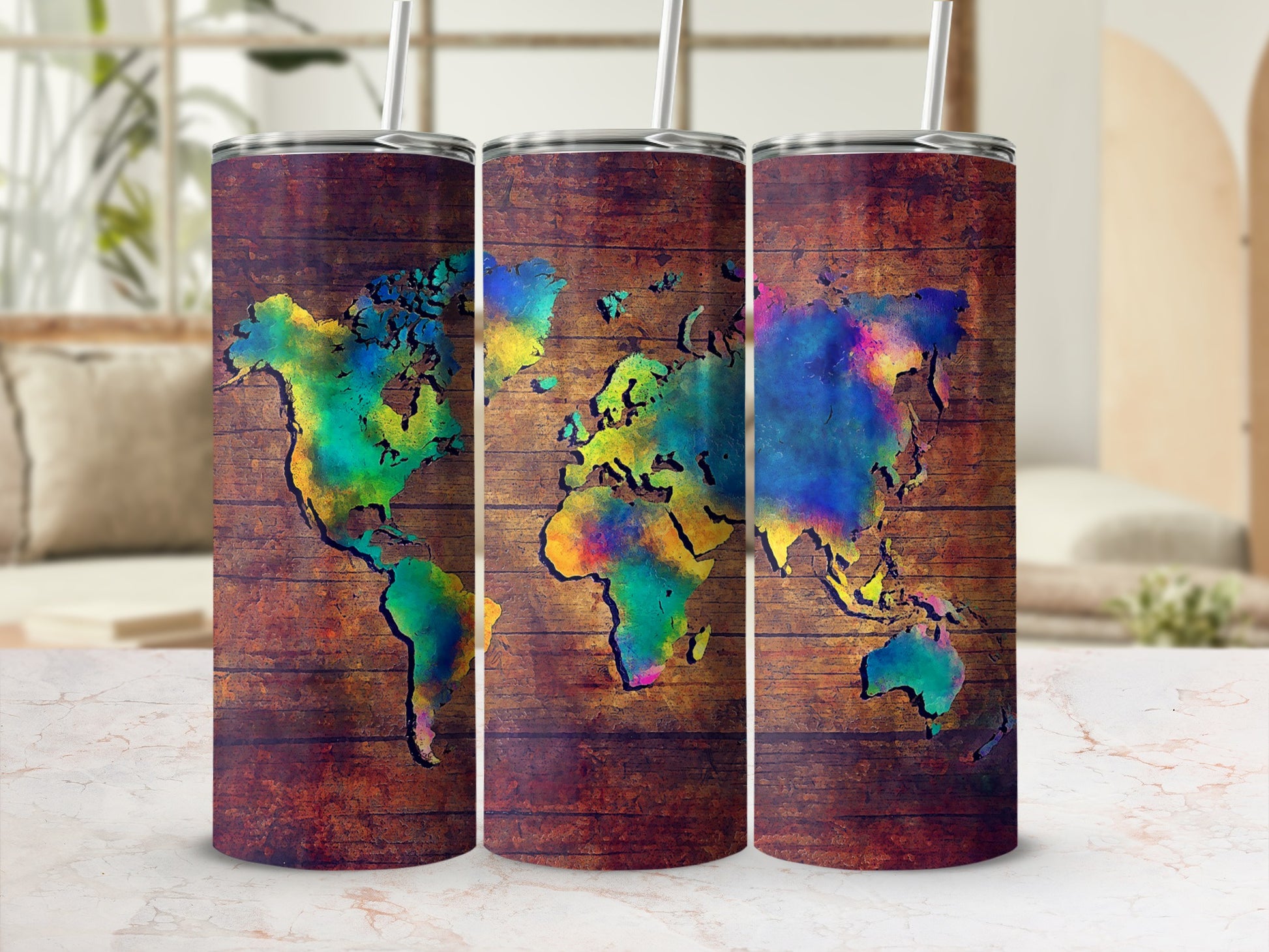 Three tumblers with a colorful world map design on a wood grain background.