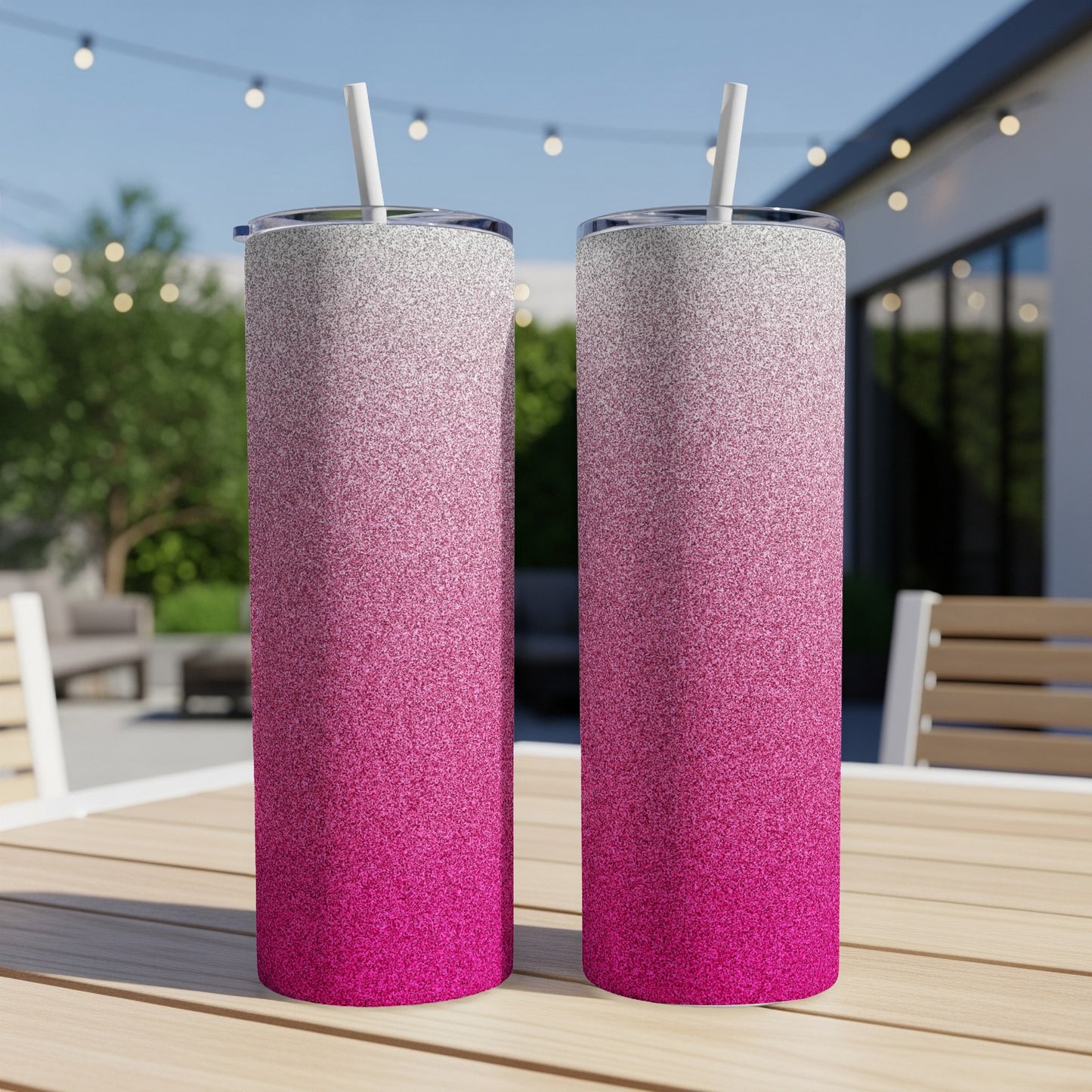 Two glitter tumblers with pink and white ombre effect on a wooden table.