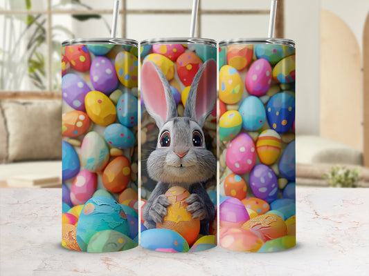 Three tumblers with a colorful Easter egg pattern and a bunny holding an egg.