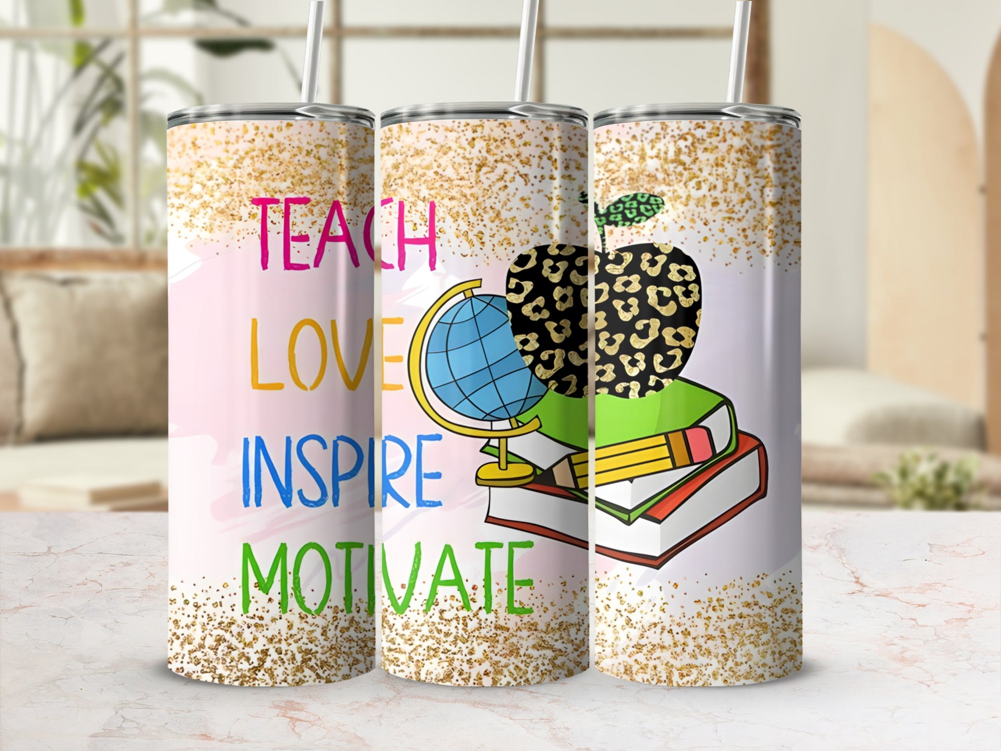 Tumbler with "Teach Love Inspire" text, globe, and apple with books.