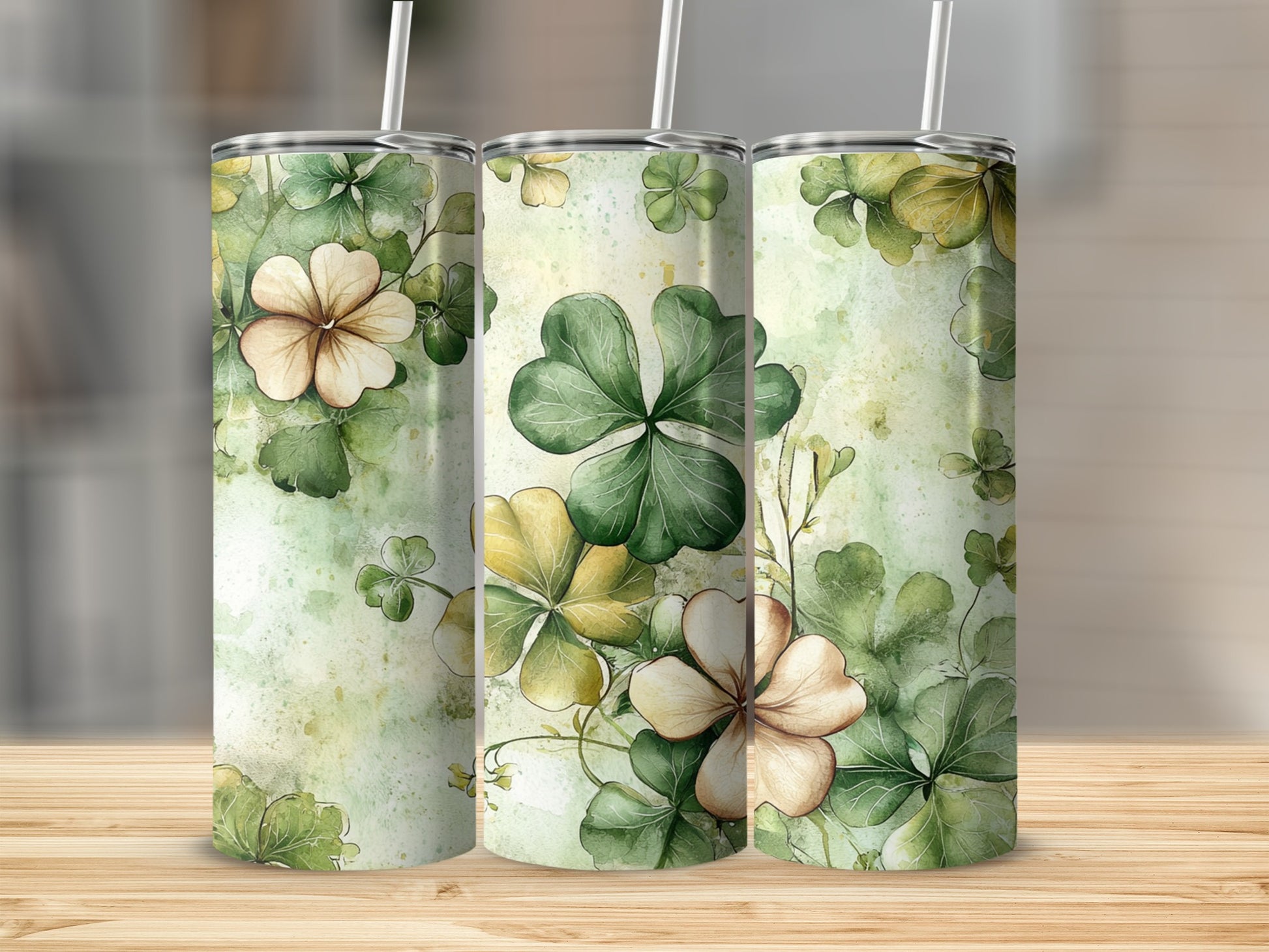 Three tumblers with a watercolor floral and clover pattern.