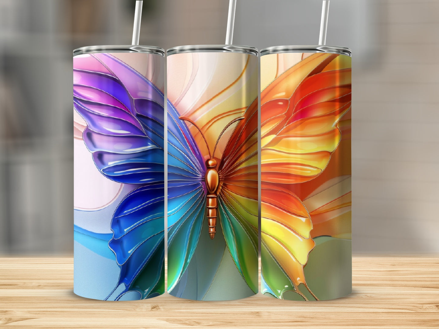 Three tumblers featuring a colorful butterfly wing design.