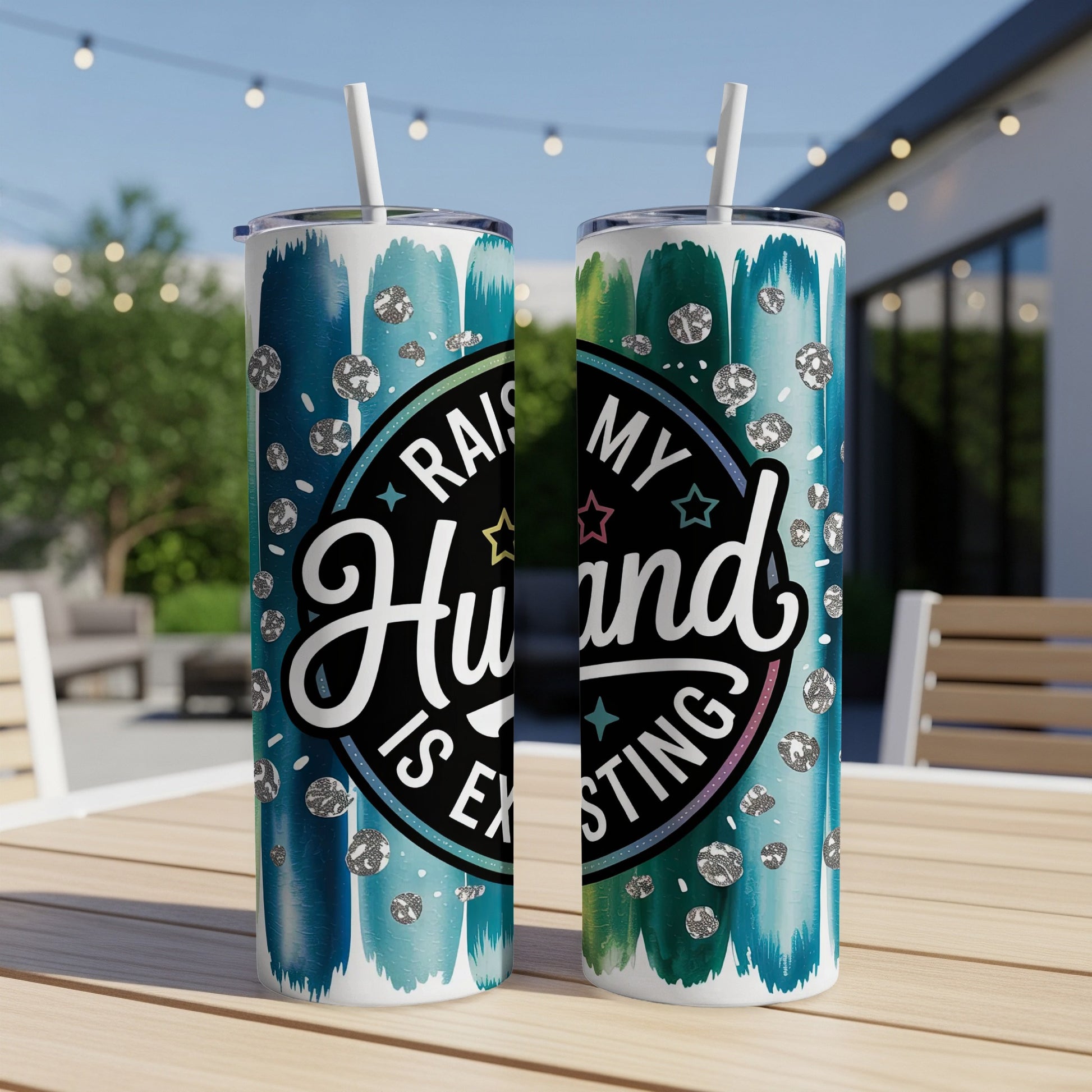 "Raising my husband is exhausting" text on a blue and green abstract brushstroke tumbler.