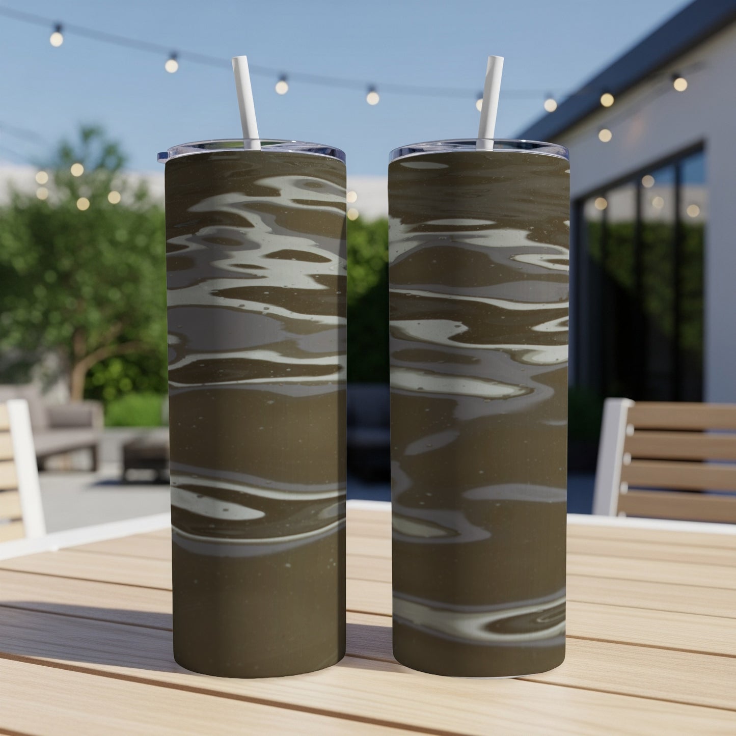 Two tumblers with a brown water ripple design sit on a wooden table.