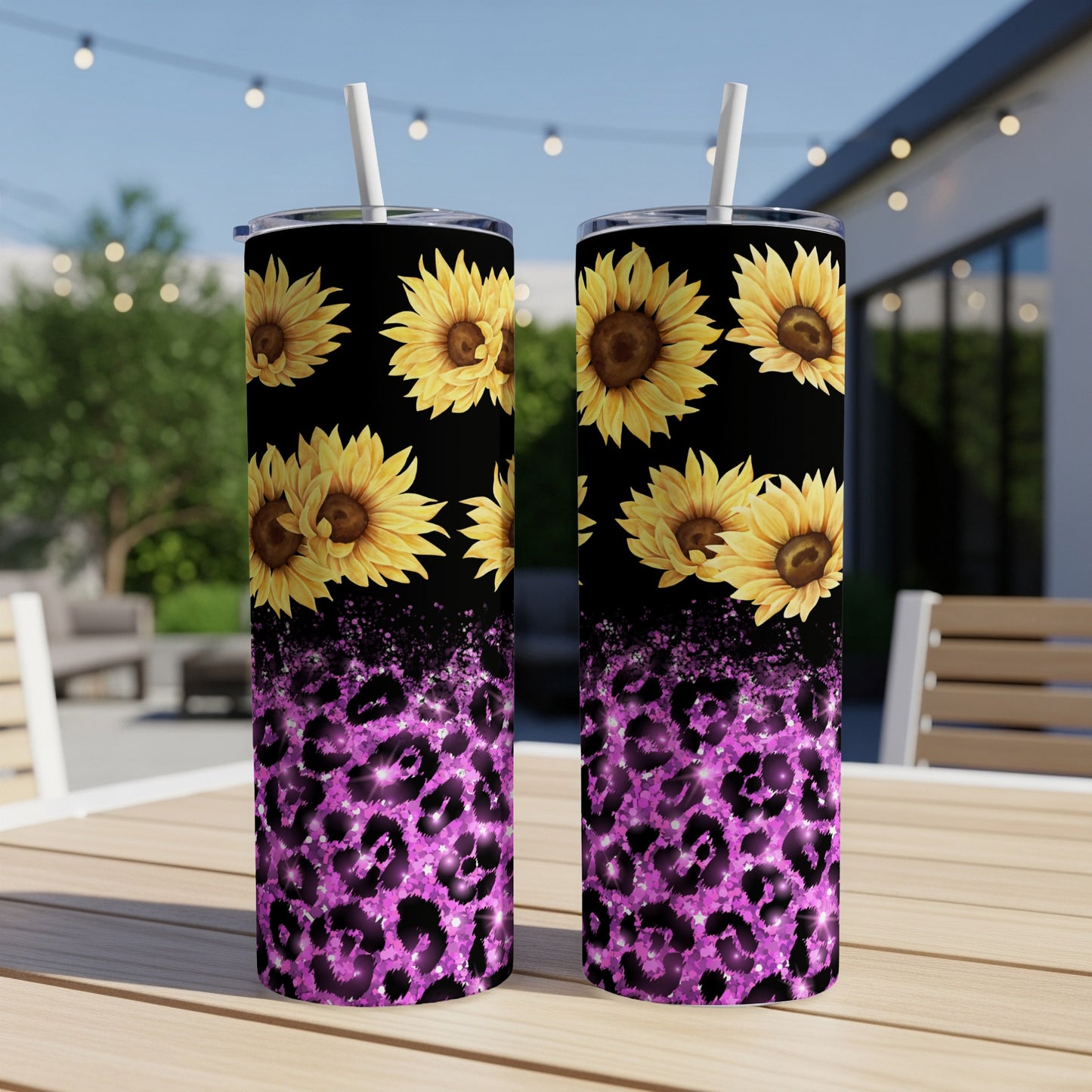 Two tumblers with sunflowers and purple leopard print on a table.