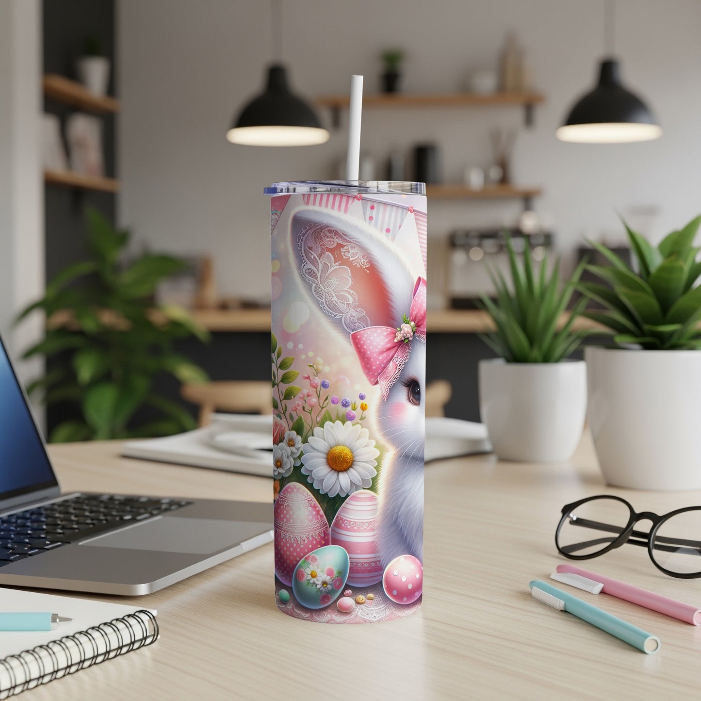 Easter bunny tumbler with pink bow, painted eggs, and flowers.