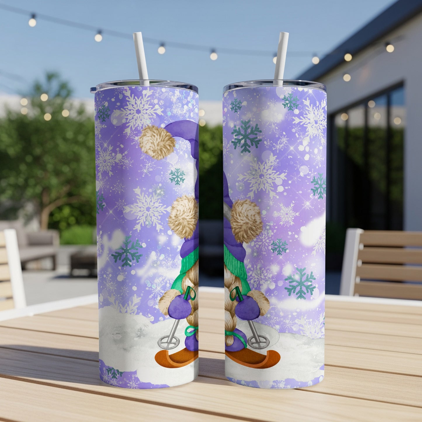 Two skinny tumblers with a purple gnome and snowflakes design.