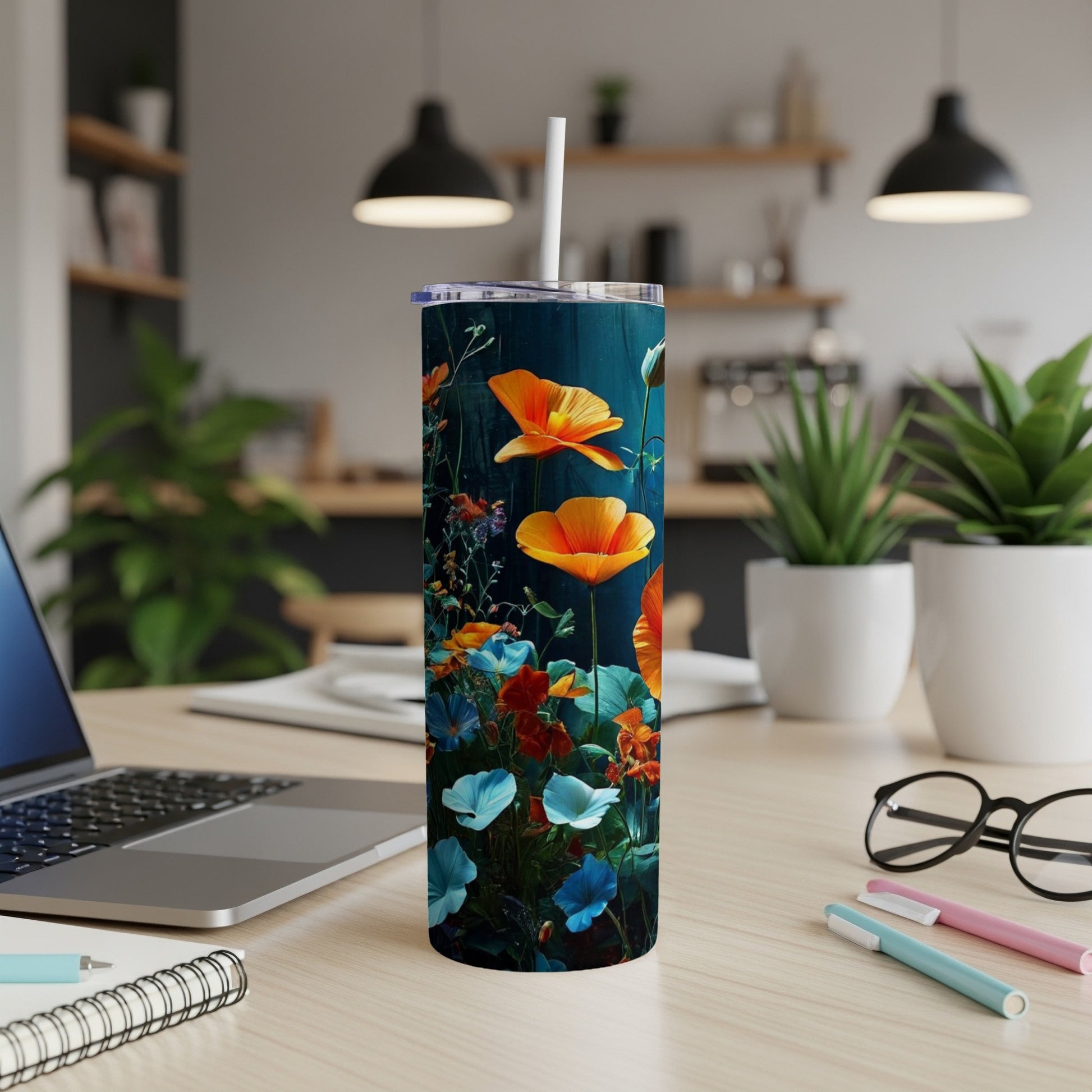 Tumbler with vibrant orange and blue wildflowers on a dark background.