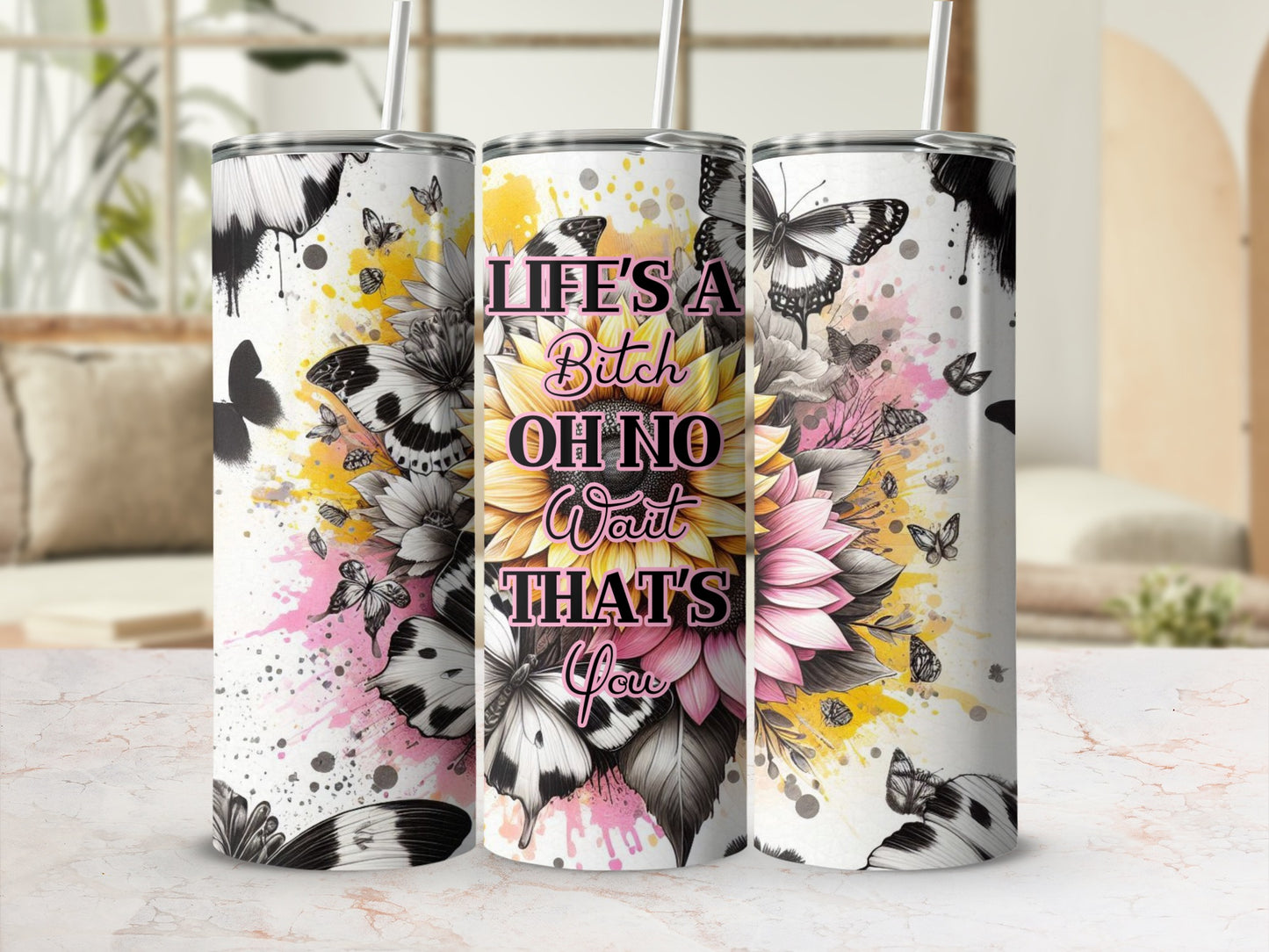 Sunflower and butterfly design on a tumbler, reads "Life's a bitch oh no wait that's you".