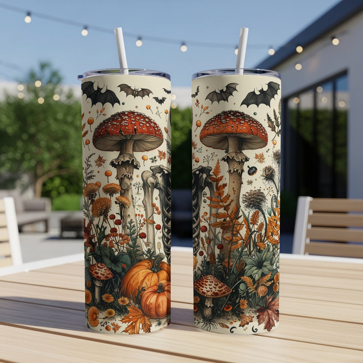 Two tumblers with a Halloween-themed print of mushrooms, pumpkins, bats, and skeletons.