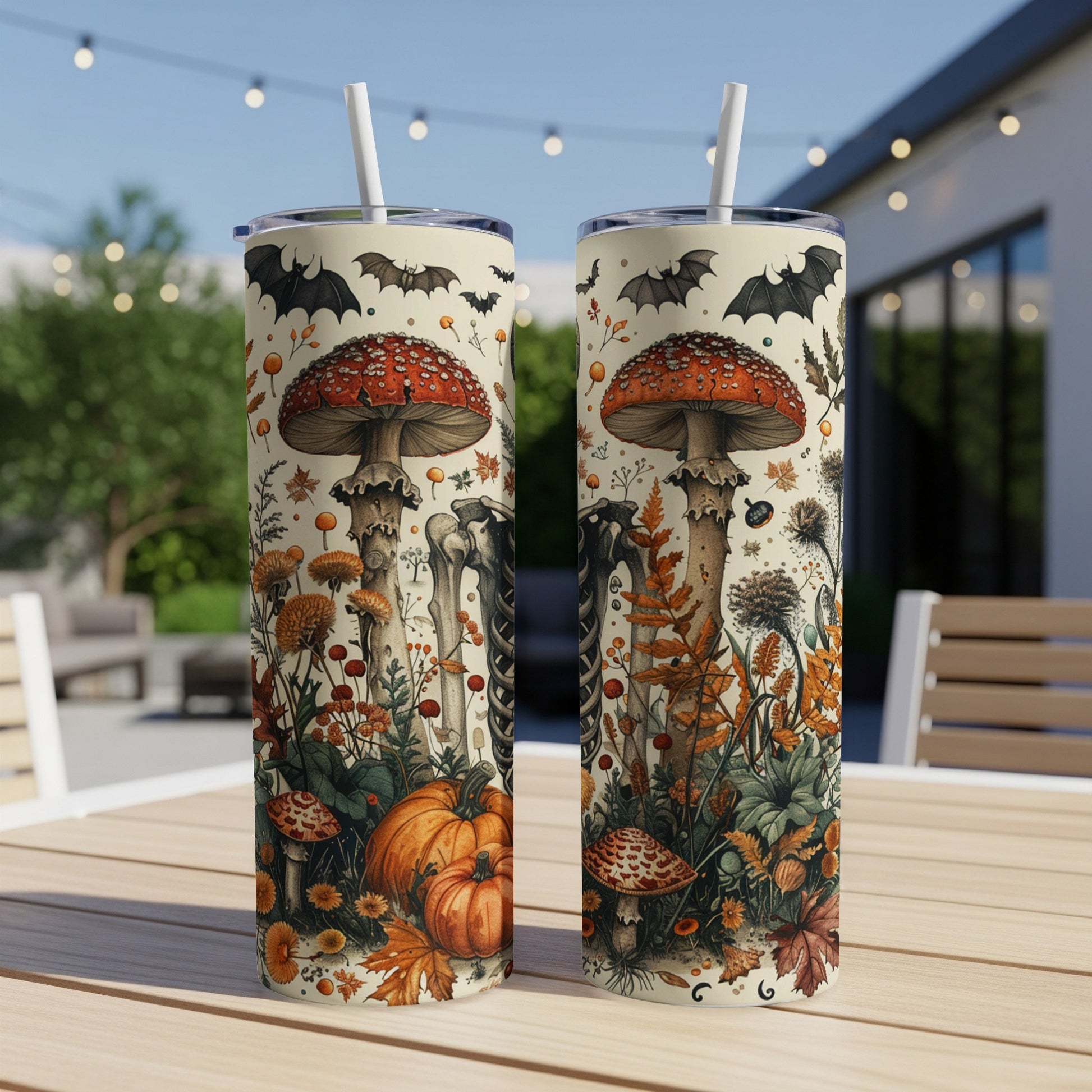 Two tumblers with a Halloween-themed print of mushrooms, pumpkins, bats, and skeletons.