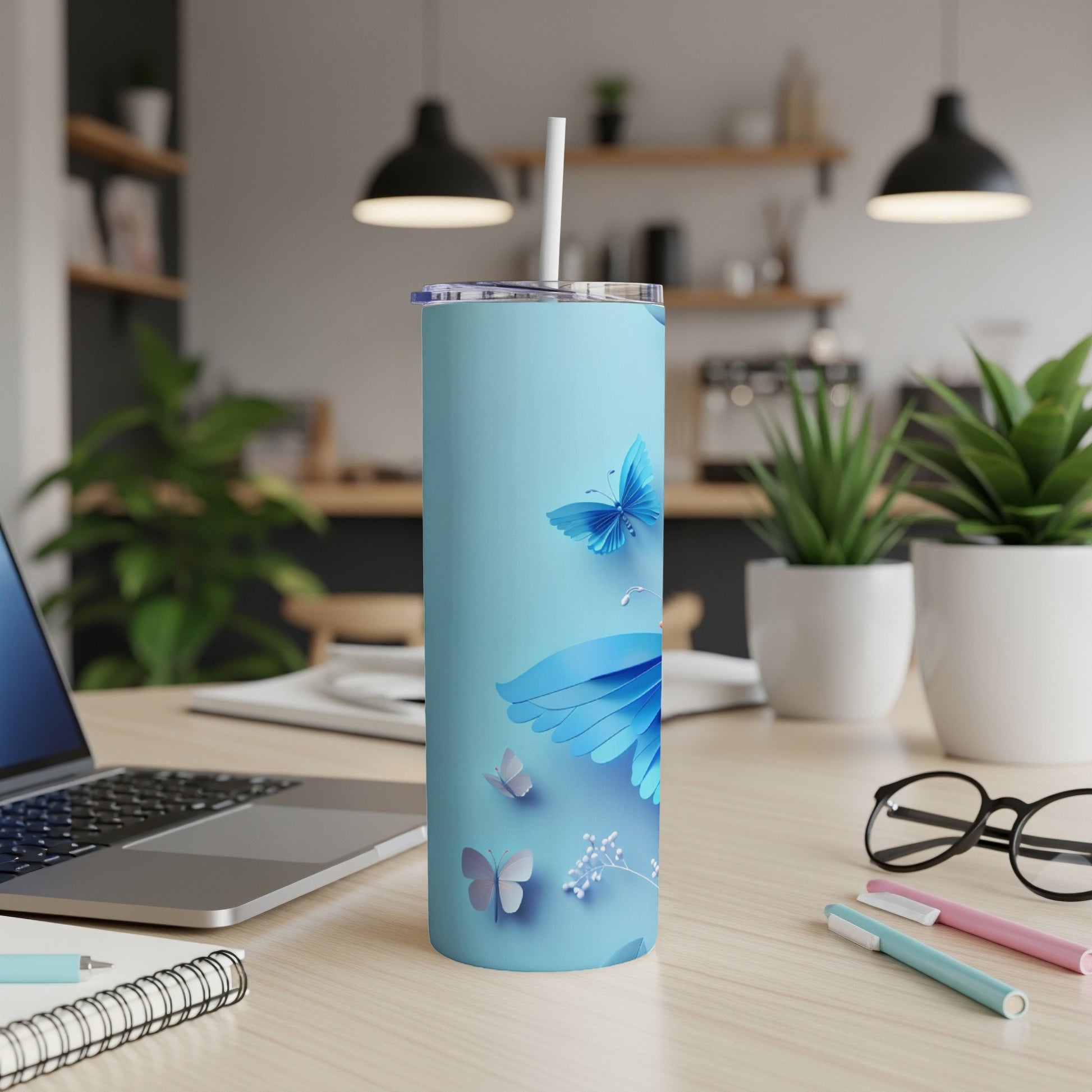 Light blue tumbler with blue butterfly pattern and white straw.